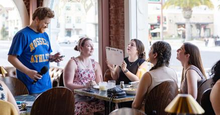 Bo hosting DANGIT Trivia, featured in the San Mateo Daily Journal